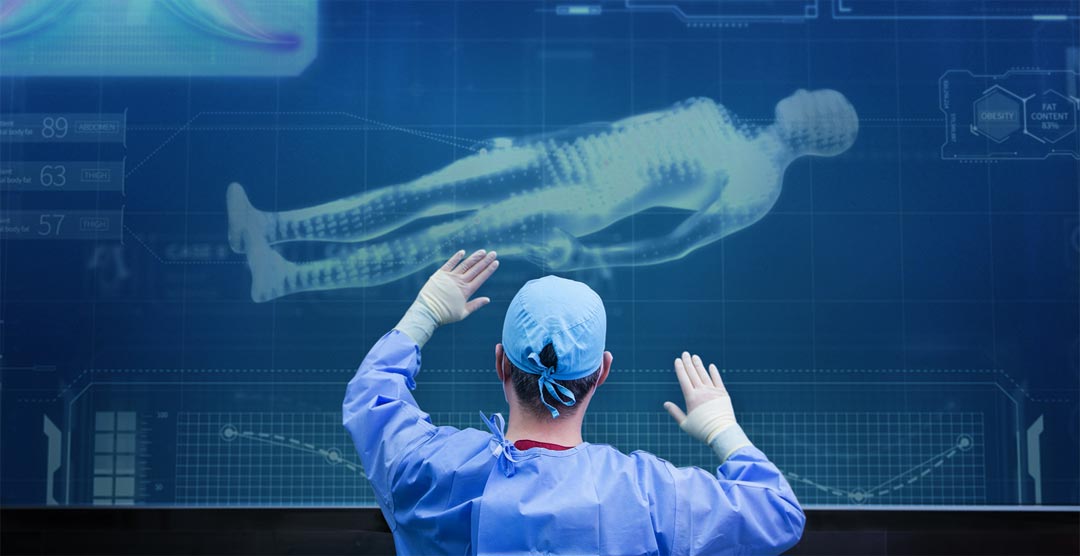 Surgeon interacting with a large digital hologram of a human body.